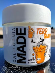 Terp in the Sun A clear glass jar holding 3.5 grams of high quality cannabis. A white label and lid with orange accents.